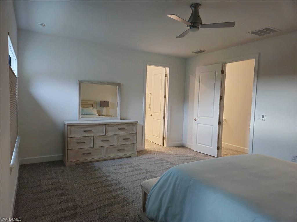 Undisclosed Address Naples, FL 34119 - Photo 23 of 50 a bedroom with a bed and a dresser