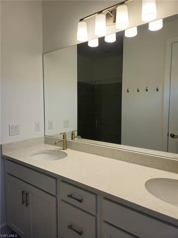 Undisclosed Address Naples, FL 34119 - Photo 26 of 50 a bathroom with a sink and a mirror
