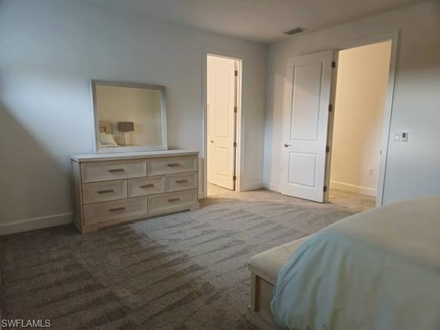 Undisclosed Address Naples, FL 34119 - Photo 28 of 50 a bed room with a bed and a mirror