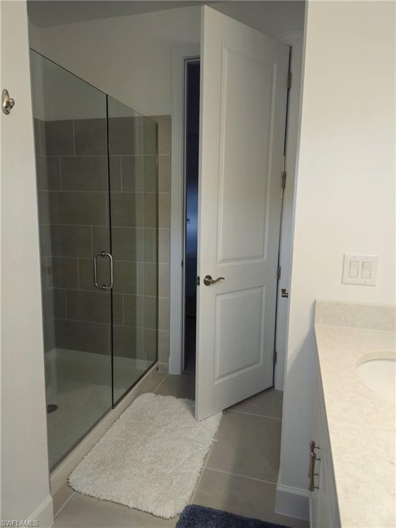 Undisclosed Address Naples, FL 34119 - Photo 30 of 50 a bathroom with a shower and a sink