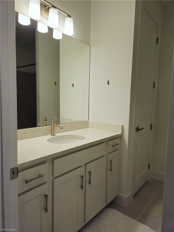 Undisclosed Address Naples, FL 34119 - Photo 31 of 50 a bathroom with a sink and a mirror