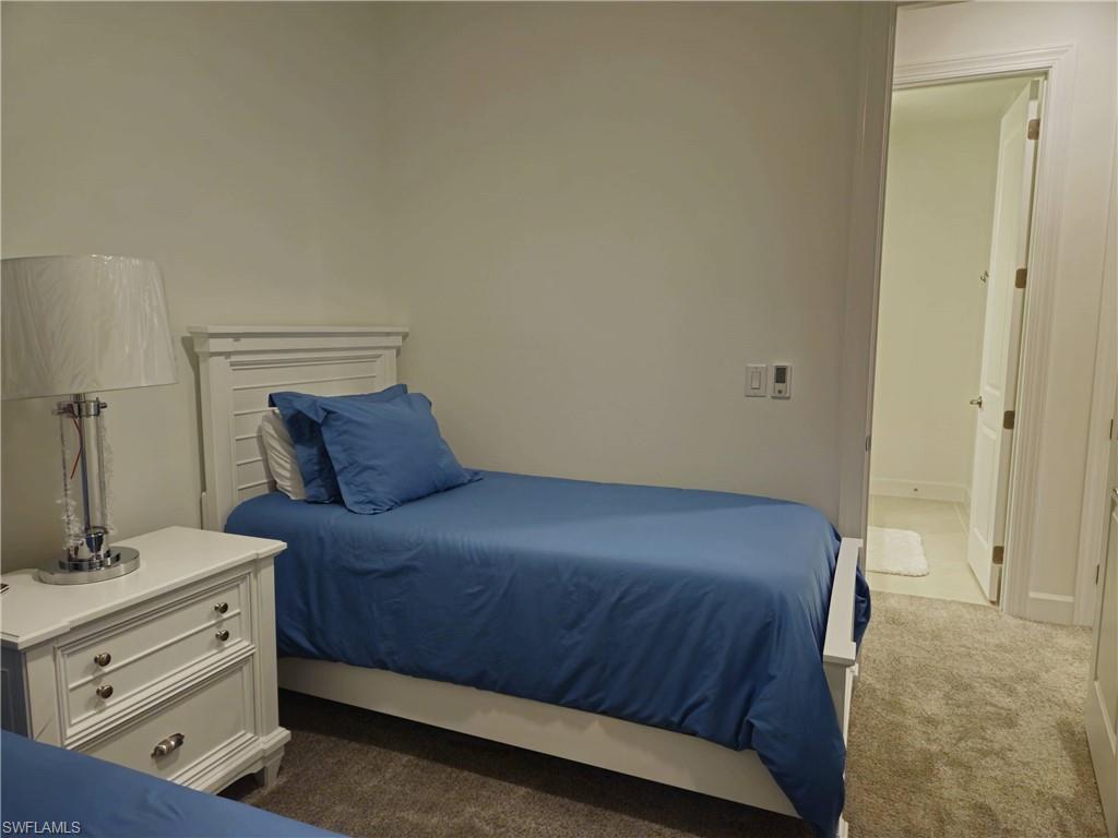 Undisclosed Address Naples, FL 34119 - Photo 36 of 50 a bedroom with a bed and a dresser
