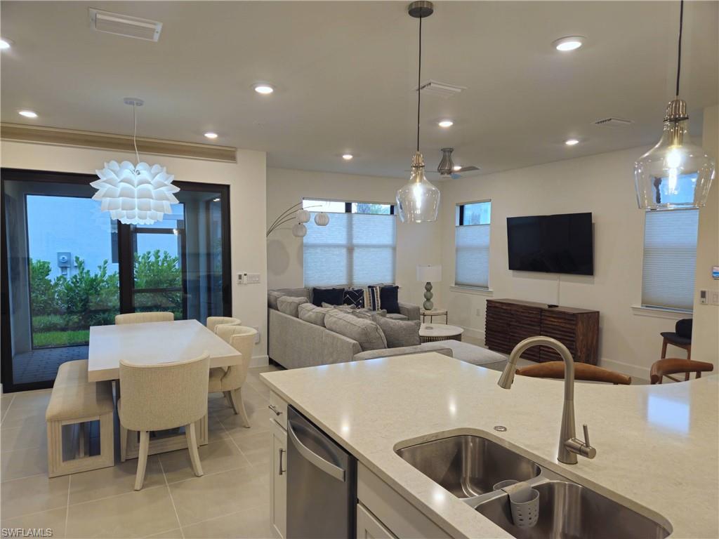 Undisclosed Address Naples, FL 34119 - Photo 4 of 50 a kitchen with a sink a counter top space and living room view
