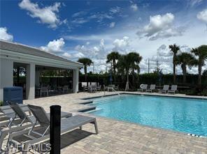 Undisclosed Address Naples, FL 34119 - Photo 41 of 50 a view of a swimming pool with outdoor seating and plants
