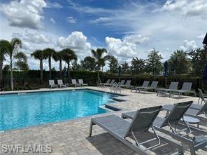 Undisclosed Address Naples, FL 34119 - Photo 43 of 50 a view of a swimming pool with lounge chairs