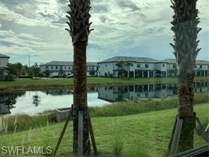 Undisclosed Address Naples, FL 34119 - Photo 49 of 50 a view of a lake with a house in a yard