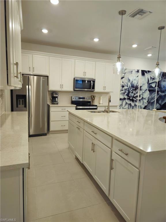 Undisclosed Address Naples, FL 34119 - Photo 7 of 50 a kitchen with refrigerator and a sink