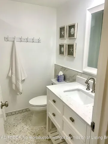 a bathroom with a toilet a sink and a mirror