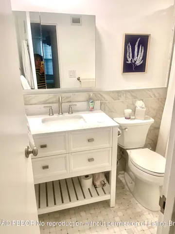 a living room with furniture and large windows