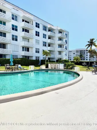 a view of a swimming pool and a yard