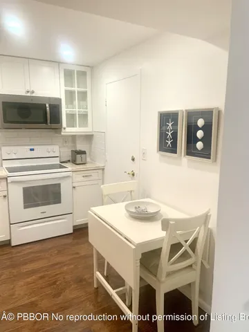 a kitchen with a sink stove top oven and refrigerator