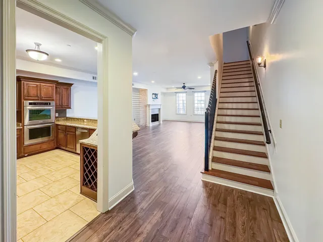 a view of a kitchen with wooden floor and stairs