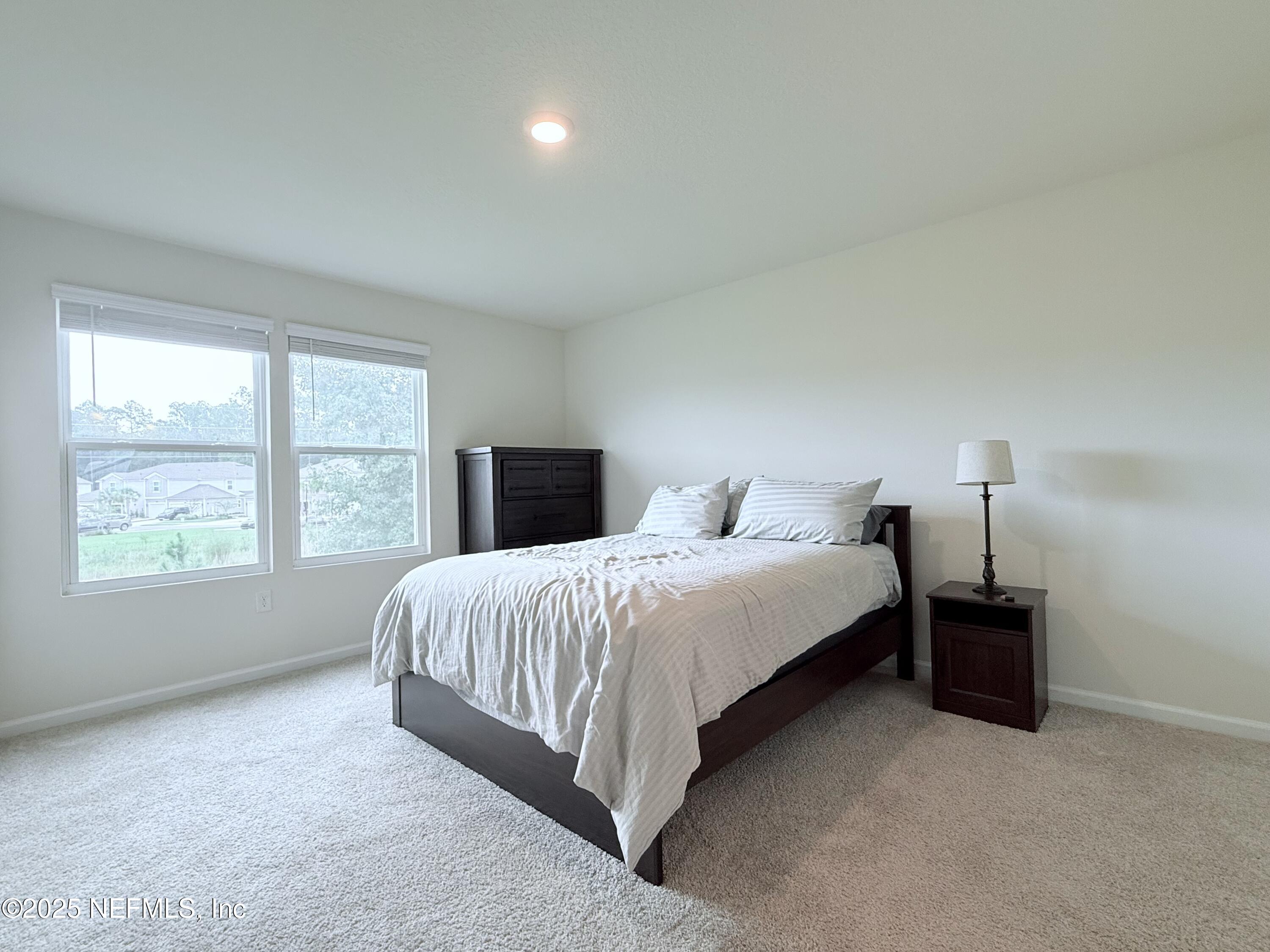 48 Java Lane St. Augustine, FL 32092 - Photo 13 of 26 a bedroom with a bed and a window