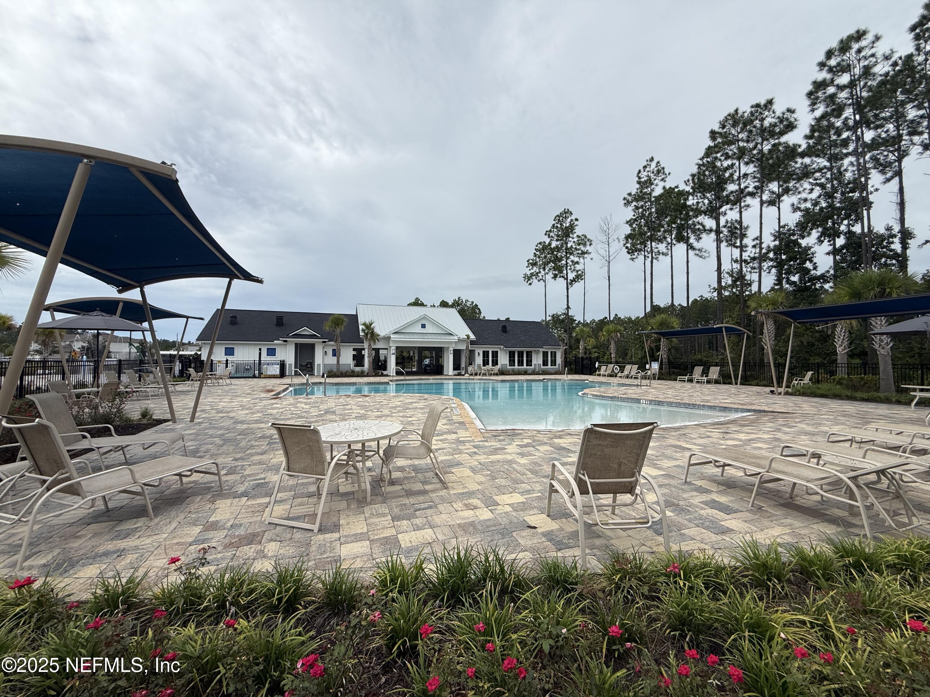 48 Java Lane St. Augustine, FL 32092 - Photo 25 of 26 a swimming pool with outdoor seating and garden