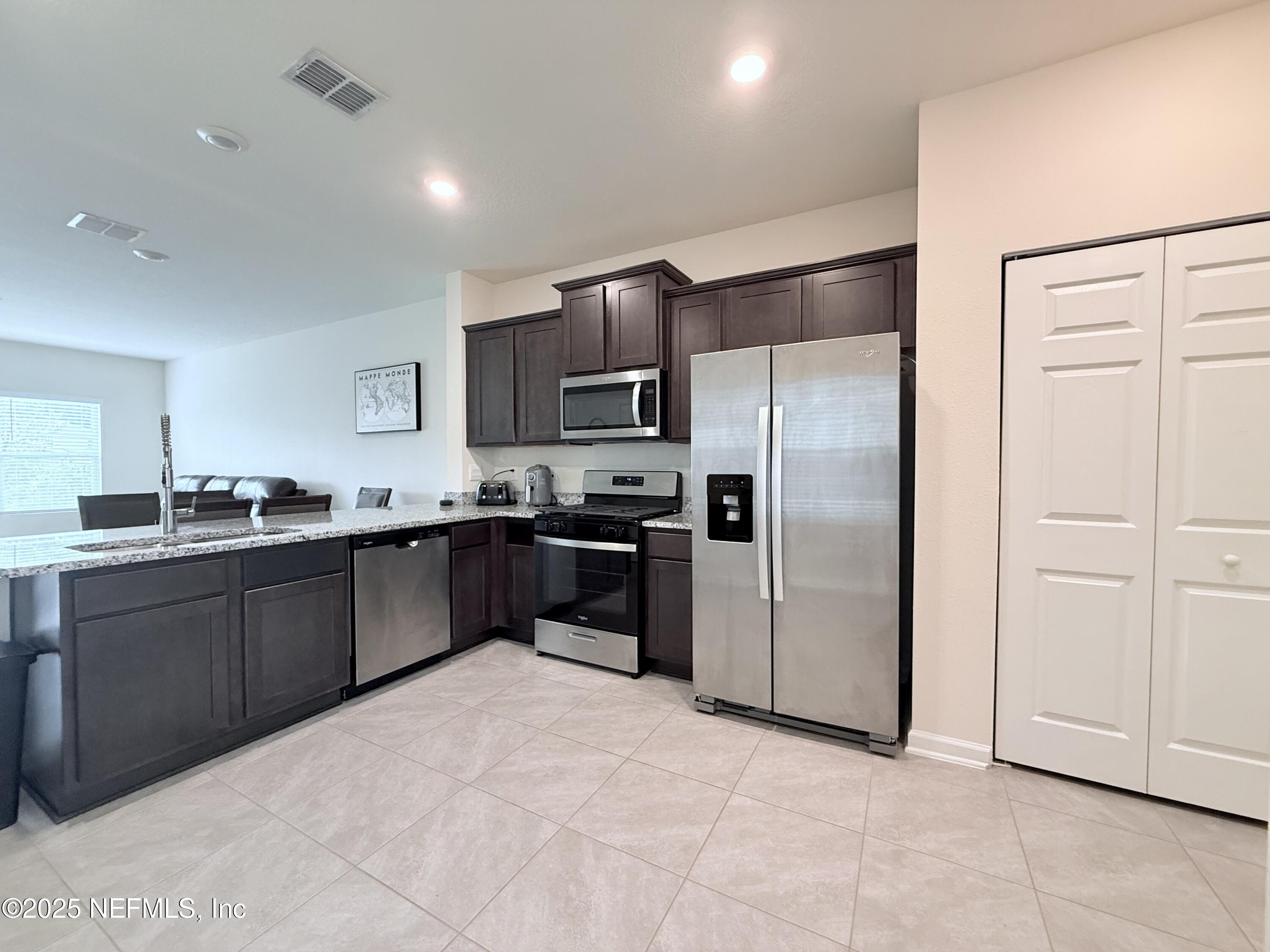 48 Java Lane St. Augustine, FL 32092 - Photo 3 of 26 a kitchen with granite countertop a refrigerator and a sink