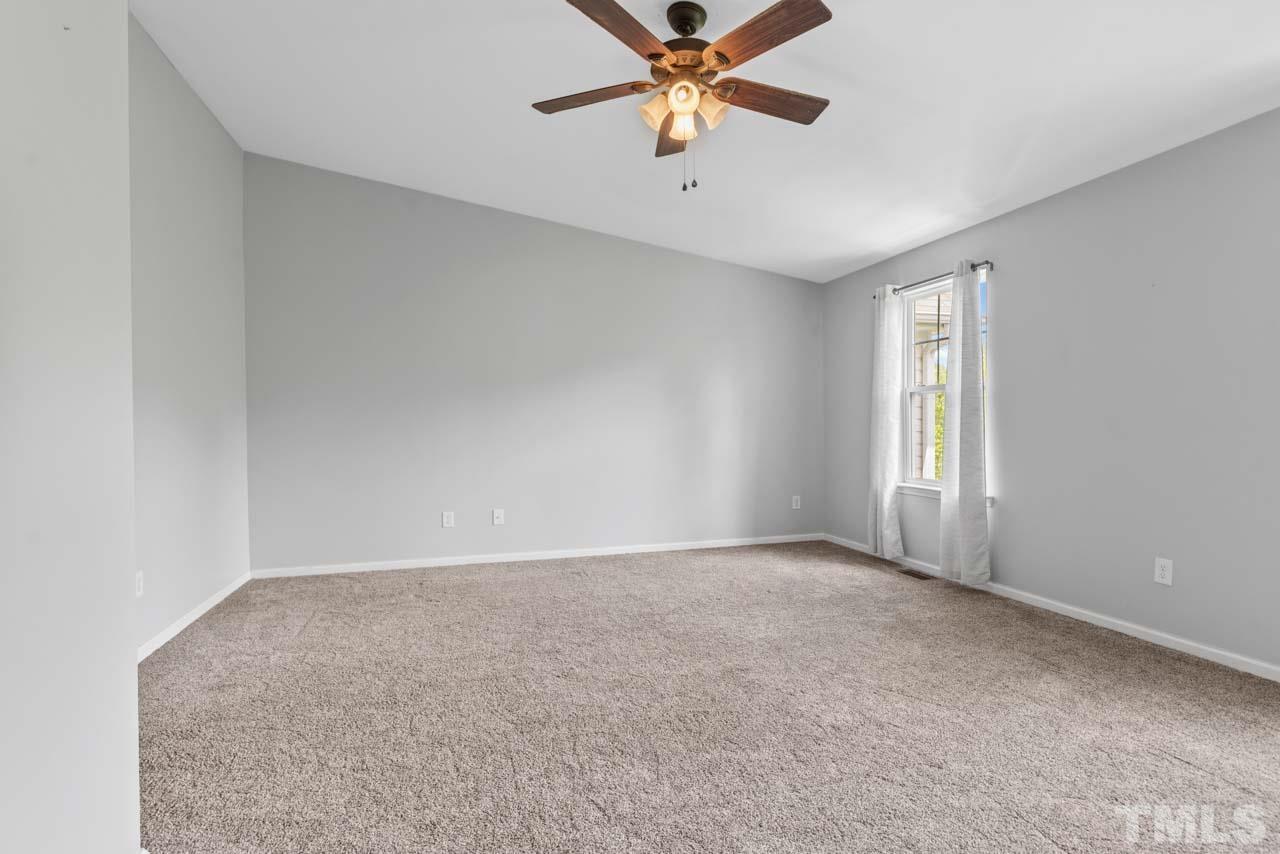 11720 Coppergate Drive, Unit 107 Raleigh, NC 27614 - Photo 20 of 26 an empty room with windows and fan