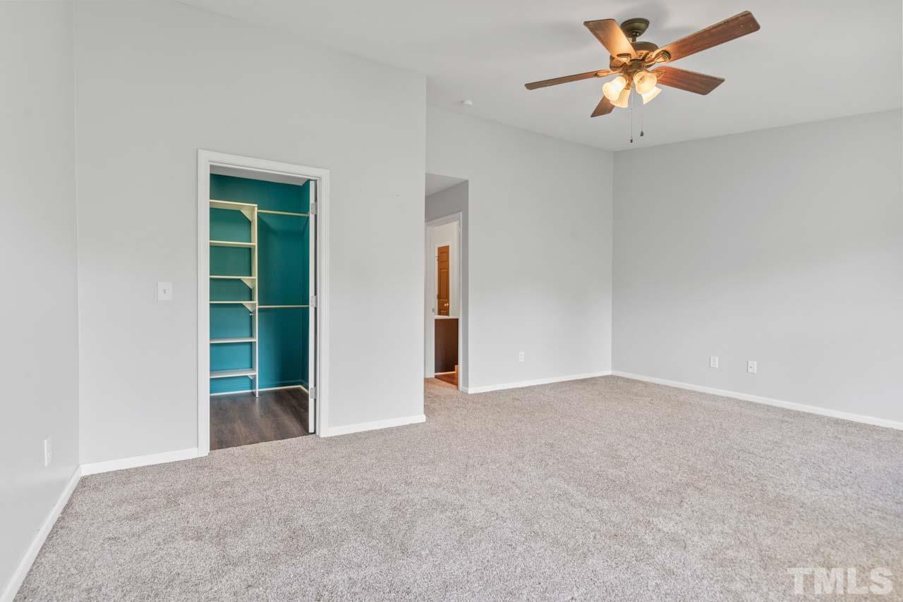11720 Coppergate Drive, Unit 107 Raleigh, NC 27614 - Photo 21 of 26 an empty room with closet and a ceiling fan