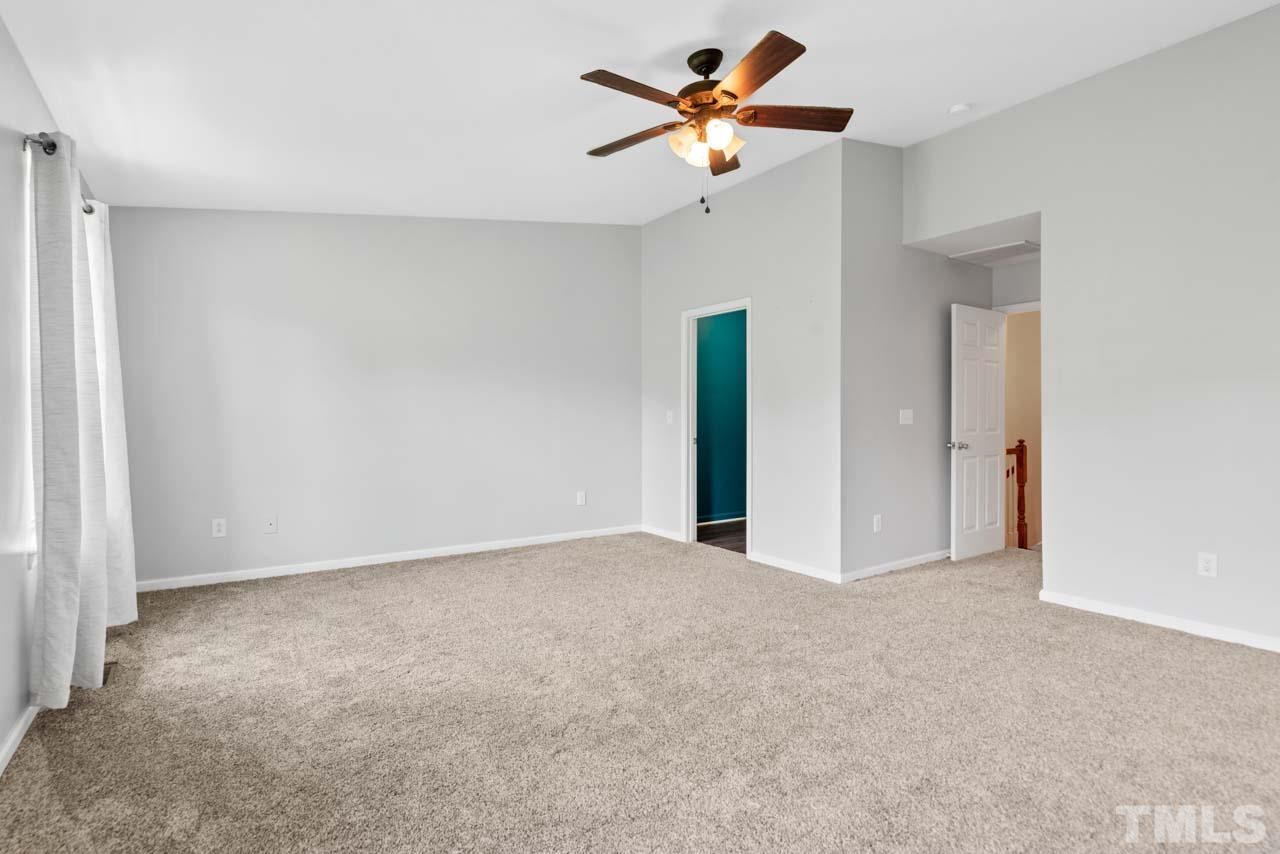 11720 Coppergate Drive, Unit 107 Raleigh, NC 27614 - Photo 22 of 26 a view of an empty room with a ceiling fan