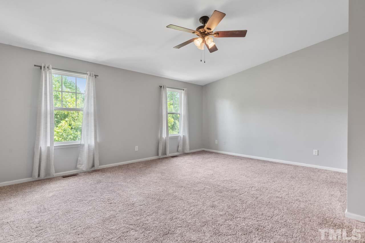 11720 Coppergate Drive, Unit 107 Raleigh, NC 27614 - Photo 23 of 26 an empty room with windows and ceiling fan view
