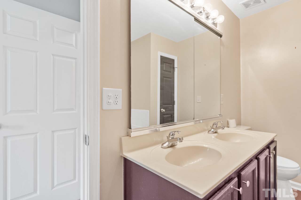 11720 Coppergate Drive, Unit 107 Raleigh, NC 27614 - Photo 25 of 26 a bathroom with a sink and a mirror