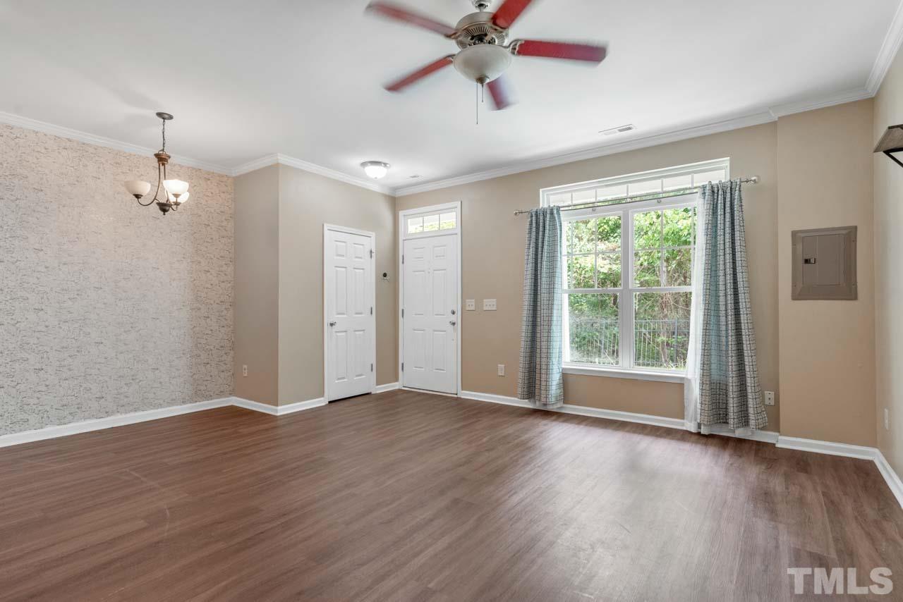 11720 Coppergate Drive, Unit 107 Raleigh, NC 27614 - Photo 7 of 26 a view of an empty room with a window and wooden floor