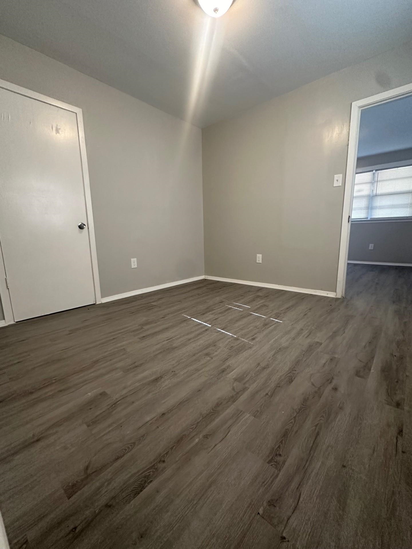 499 Baltimore Street Memphis, TN 38111 - Photo 8 of 9 a view of an empty room with wooden floor and a window