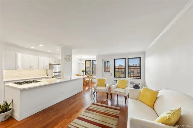 a living room with furniture and kitchen view