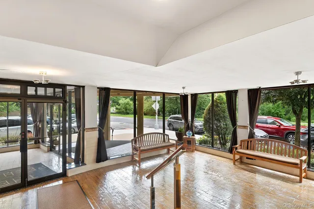 a living room with large windows and furniture