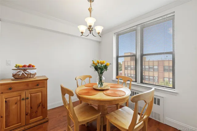 a dining room with furniture a chandelier and wooden floor