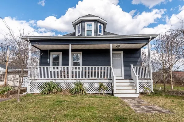 a front view of a house with a garden