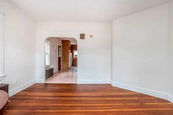 a view of a room with wooden floor and white walls