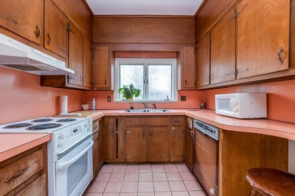 a kitchen with a sink stove and cabinets