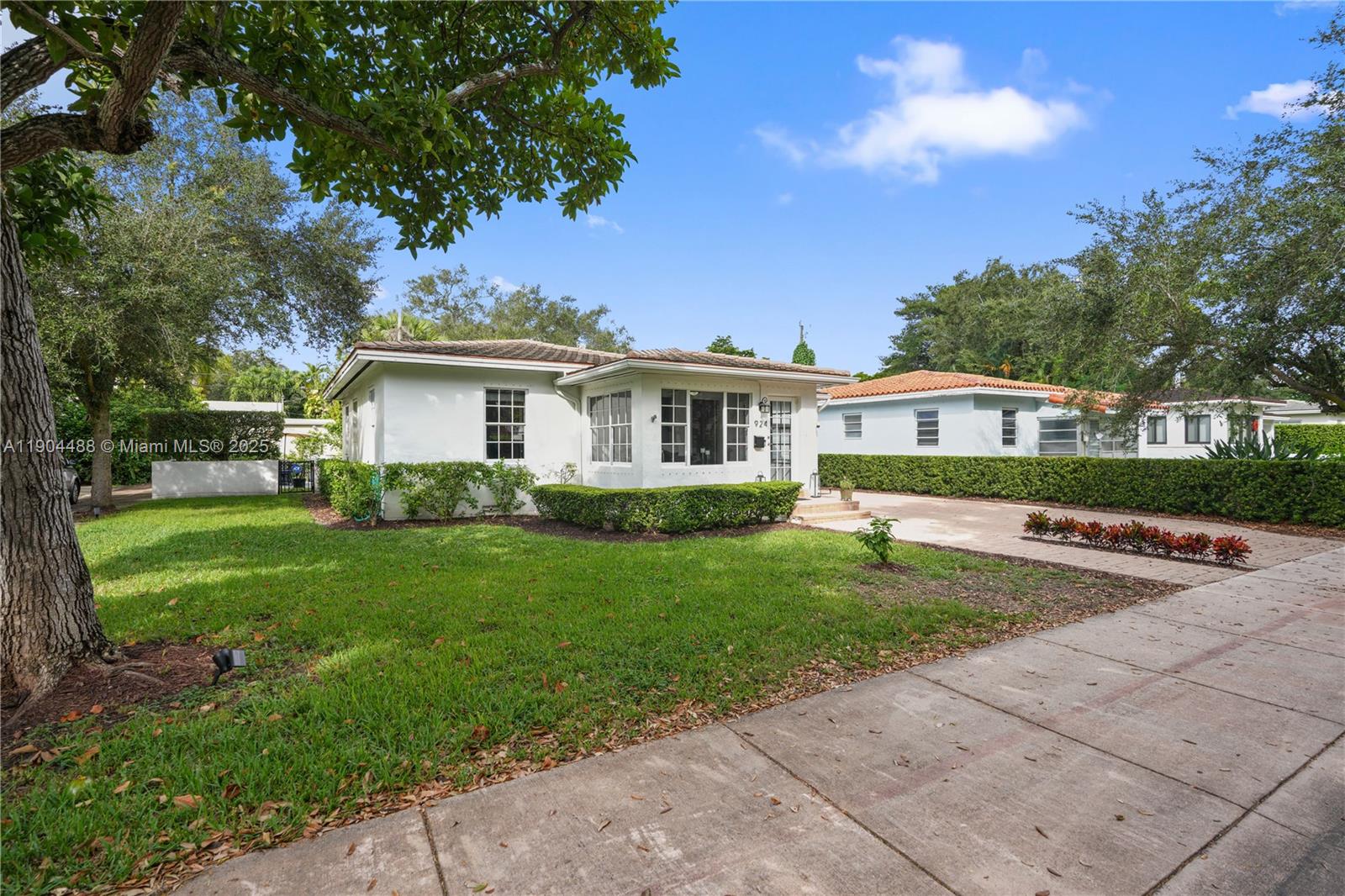 924 El Rado Street Coral Gables, FL 33134 - Photo 27 of 28 a front view of house with yard and green space