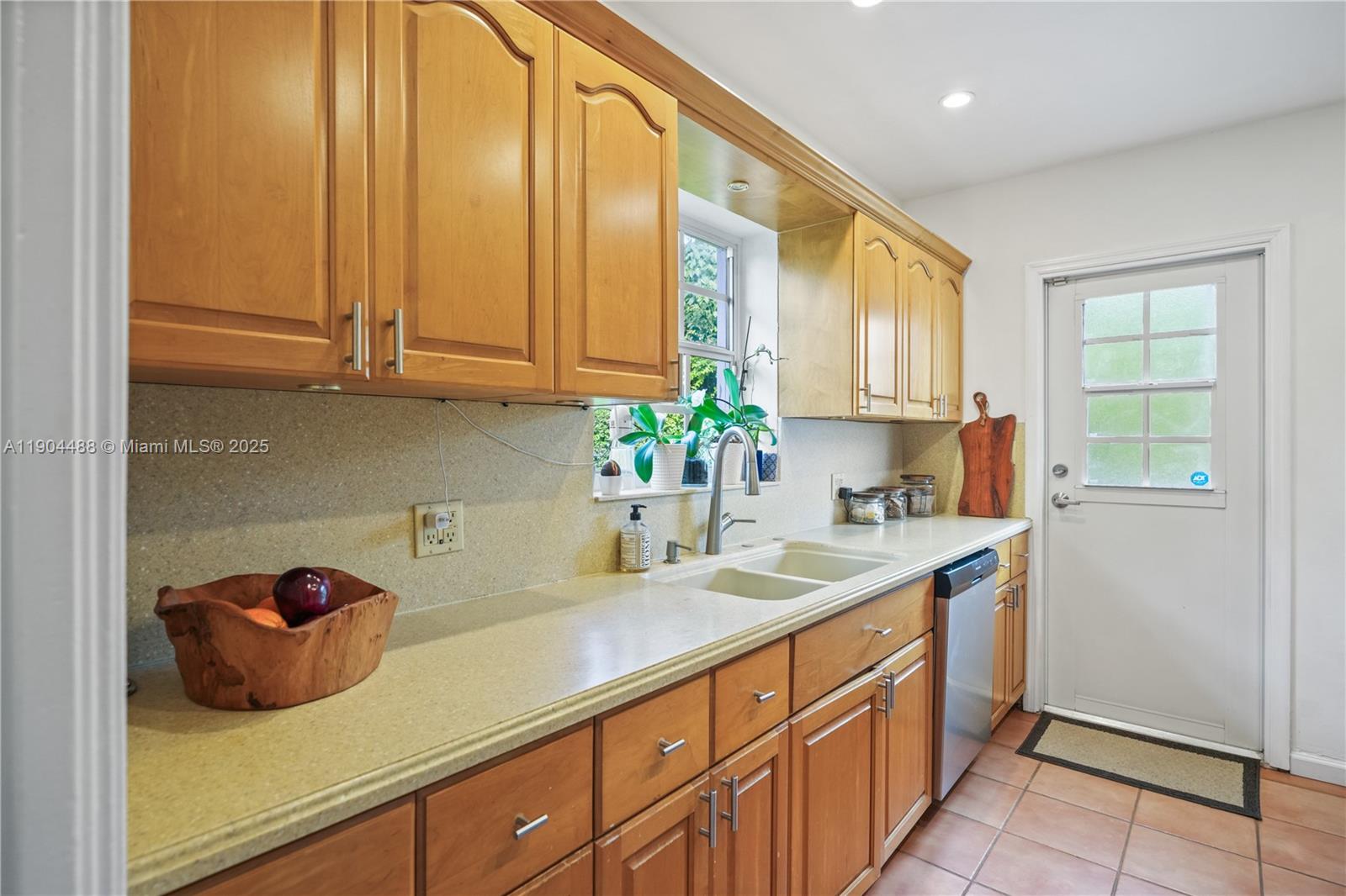 924 El Rado Street Coral Gables, FL 33134 - Photo 9 of 28 a kitchen with stainless steel appliances granite countertop a sink a refrigerator and a stove