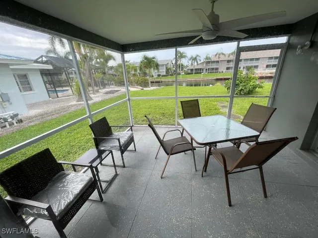 a view of a porch with furniture and a yard