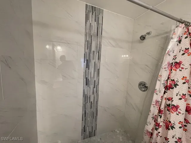 a bathroom with a shower and a sink