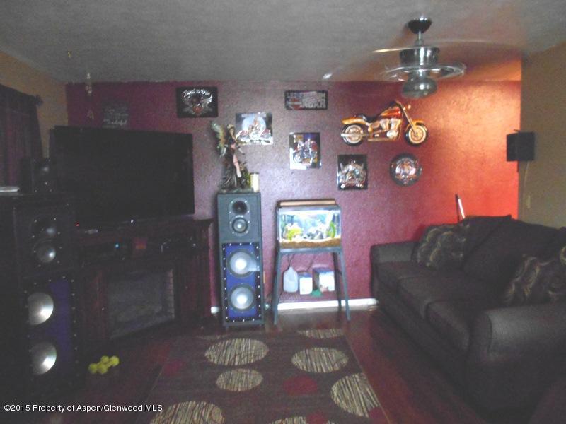627 Fairway Avenue Rifle, CO 81650 - Photo 4 of 9 a living room with furniture and a chandelier
