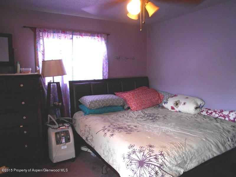 627 Fairway Avenue Rifle, CO 81650 - Photo 7 of 9 a bedroom with a bed and a lamp