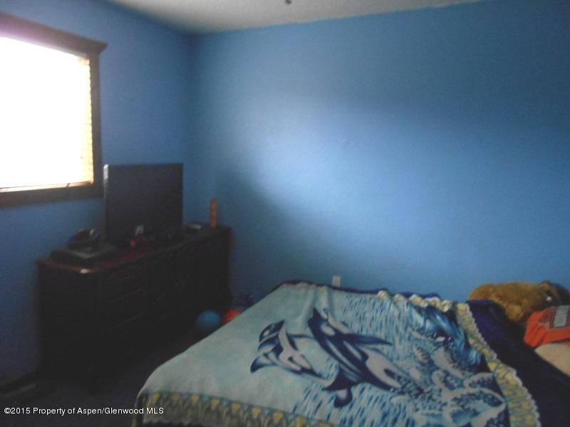 627 Fairway Avenue Rifle, CO 81650 - Photo 8 of 9 a bed sitting in a bedroom next to a window