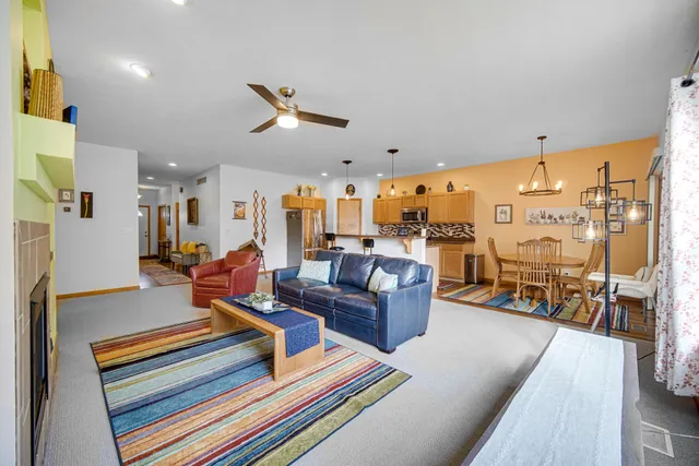 a living room with lots of furniture and a table
