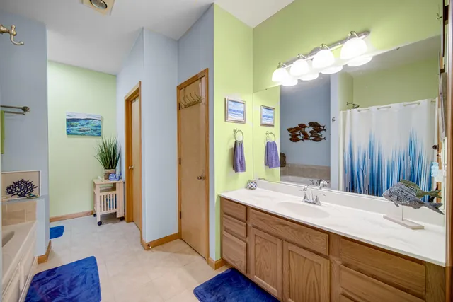 a bathroom with a double vanity sink mirror and shower