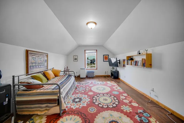 a bedroom with furniture and a rug