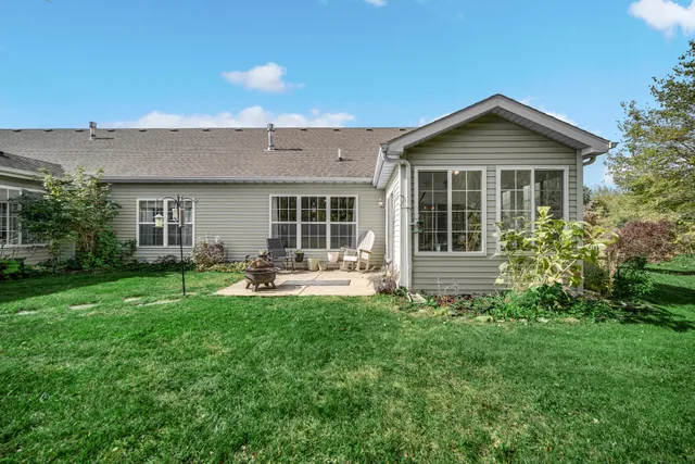 a front view of a house with patio and garden