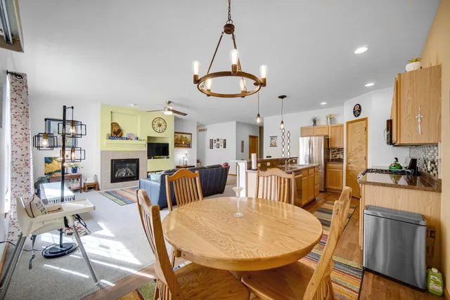 a living room with furniture a fireplace and kitchen view