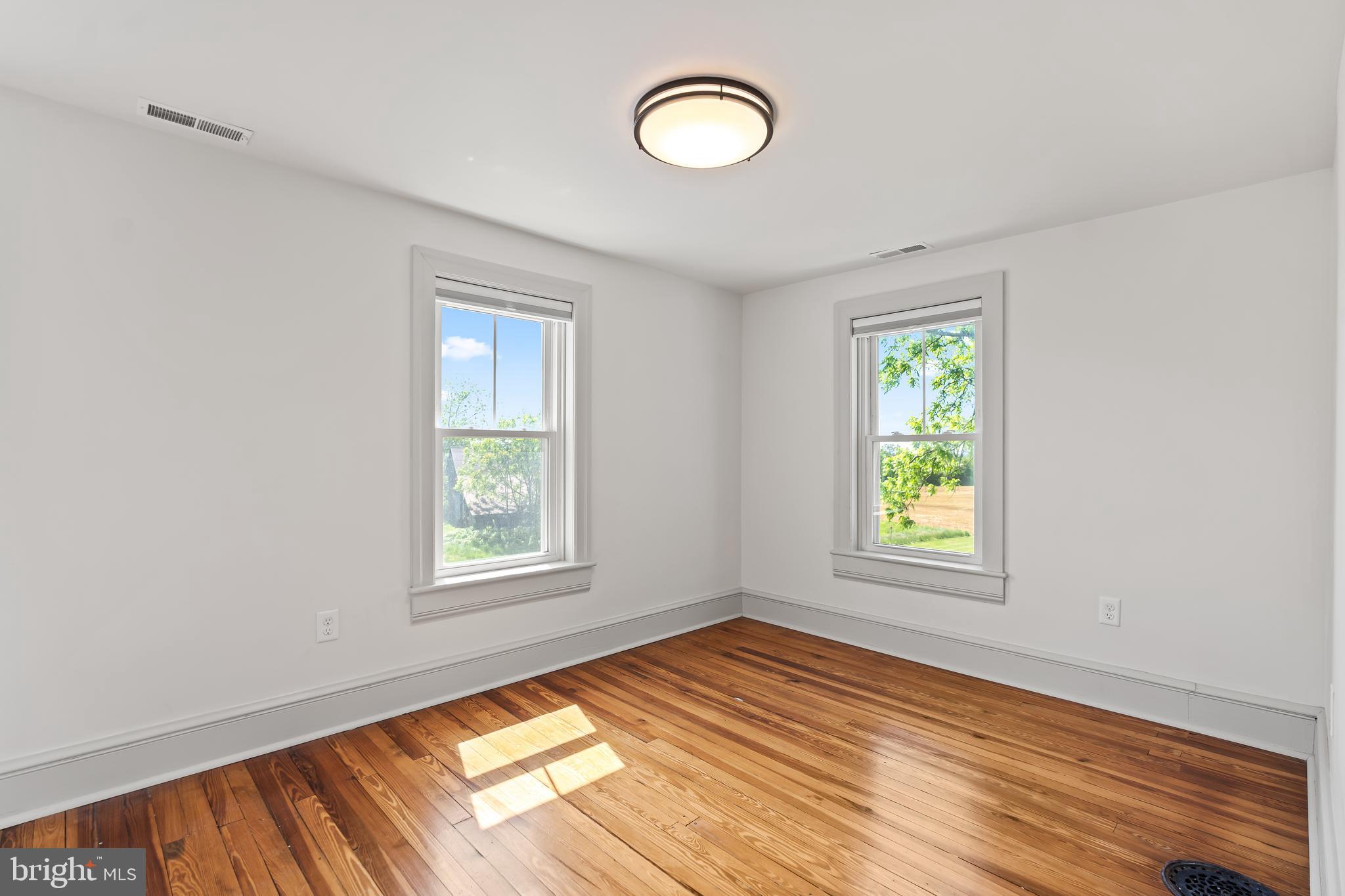 14005 Dry Run Road Clear Spring, MD 21722 - Photo 32 of 44 an empty room with wooden floor and windows