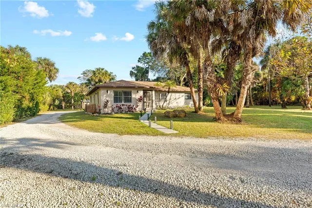 a view of house with outdoor space and swimming pool