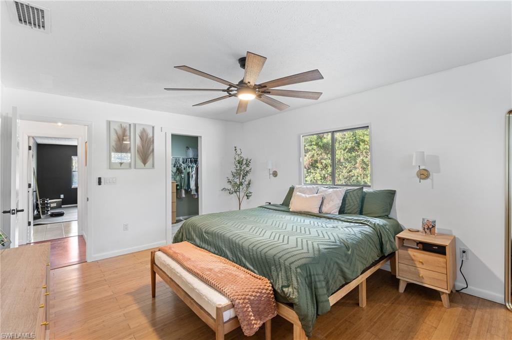 1030 13th Street Southwest Naples, FL 34117 - Photo 11 of 43 a bedroom with a bed and a chandelier