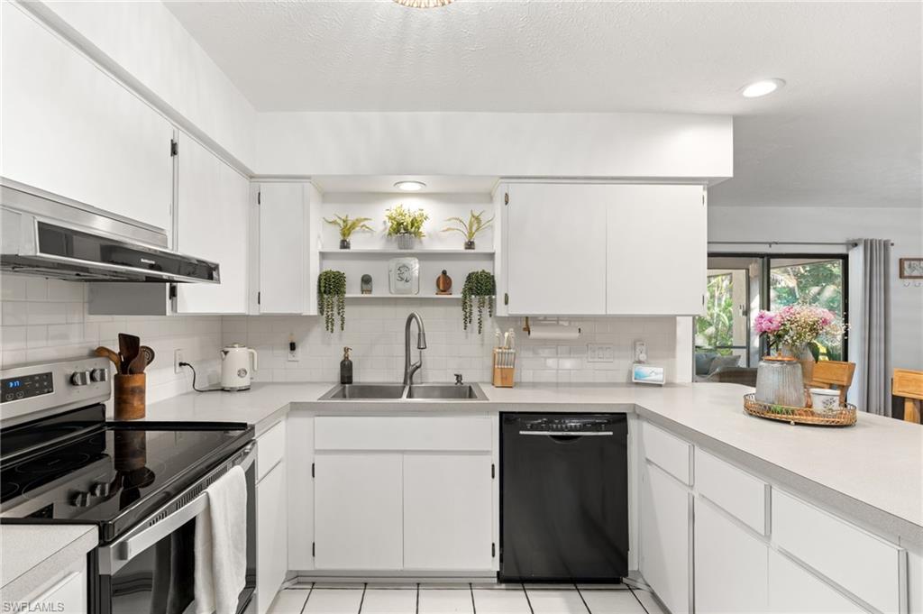 1030 13th Street Southwest Naples, FL 34117 - Photo 16 of 43 a kitchen with a sink dishwasher and stove