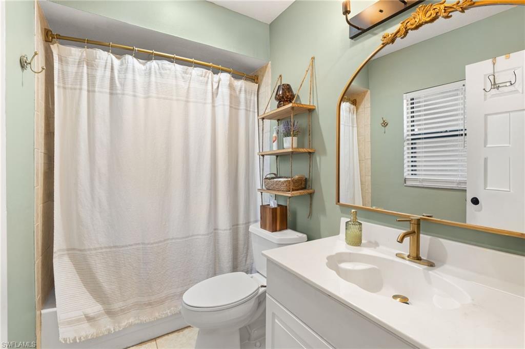 1030 13th Street Southwest Naples, FL 34117 - Photo 19 of 43 a bathroom with a sink a toilet and shower
