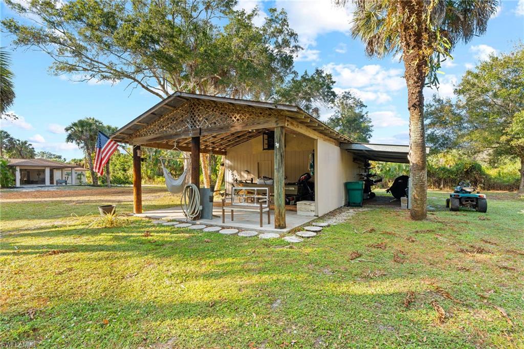 1030 13th Street Southwest Naples, FL 34117 - Photo 2 of 43 a view of a house with basketball court
